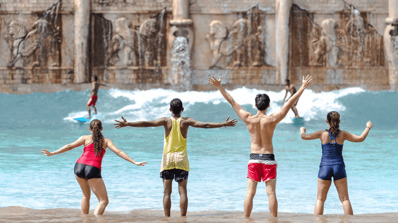 Rear view of four enjoying Lagoon water park near Sunway Lagoon