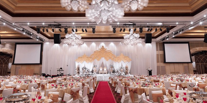 The Imperial Ballroom featuring set-up banquets facing the grand stage and a large screen at One World Hotel