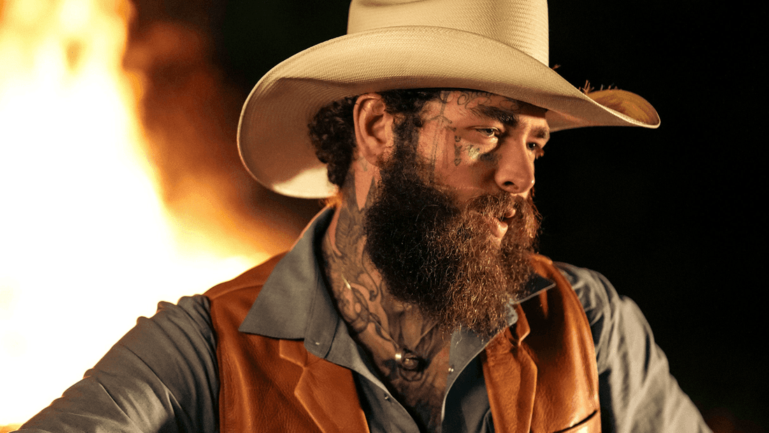 Post Malone wearing cowboy hat and vest with tattoos on his face for The BIG ASS World Tour 2026.