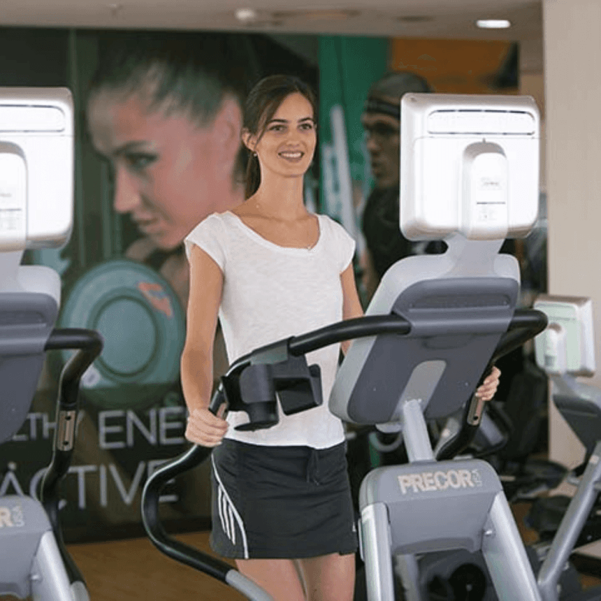 A girl exercising on a treadmill in gym at 2 Seasons H. & Apt