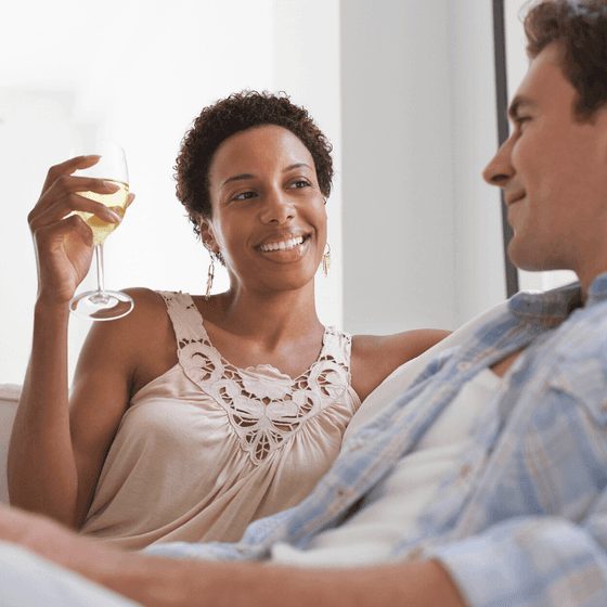 A man and woman relax with a glass of wine at our Wildwood Crest NJ hotel