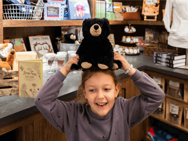 Kid posing while holding a toy in Union City Market near Alderbrook Resort & Spa