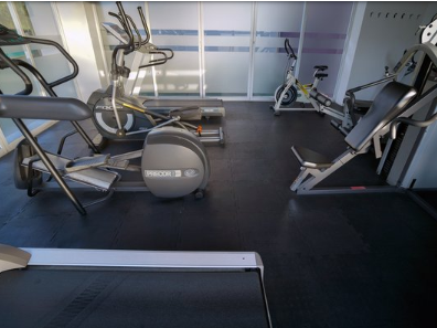 Interior of the gym with fitness machines at Gamma Hotels