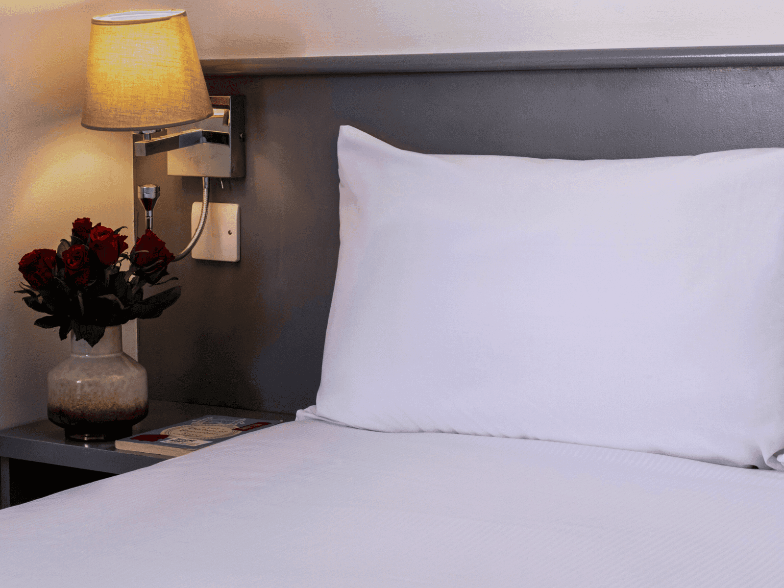 Close up view of bed with side table - St Giles London Hotel