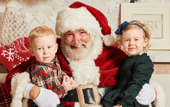Kids smile for a photo with Santa at our Diamond Beach hotel