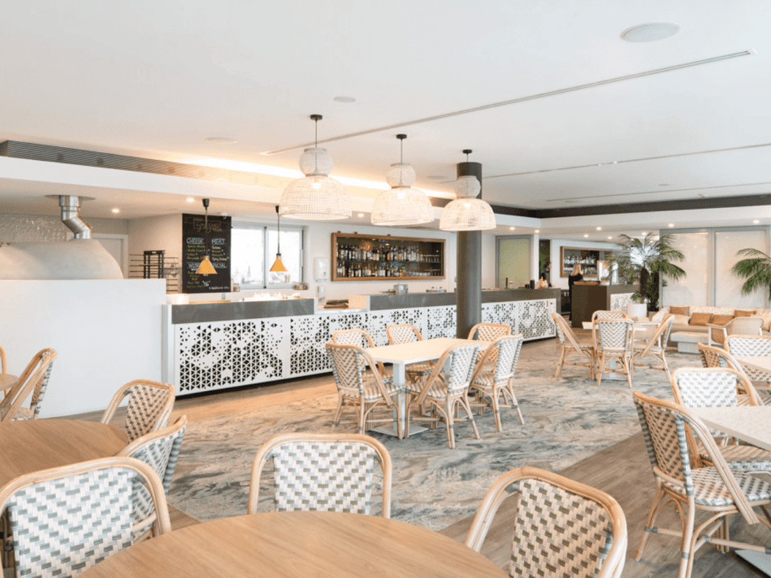 Interior & decor of the Shallows Bar with marble floors at Pullman Magenta Shores