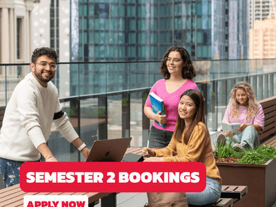 Students studying on a rooftop terrace with city views at UniLodge Melbourne Central.