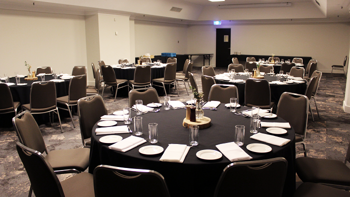 Set up banquets under ceiling lights and carpet floors in Hibiscus at Novotel Sydney International Airport