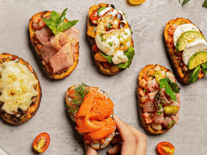 A person holds a plate of food, showcasing a colorful and appetizing meal ready to be enjoyed.