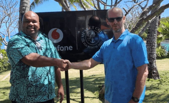 Men shaking hands featuring Vodafone Fiji Manager Sponsorship at Musket Cove Island Resort & Marina