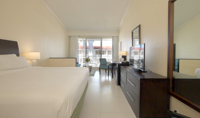 Bedroom interior of a Junior Suite at Holiday Inn Montego Bay