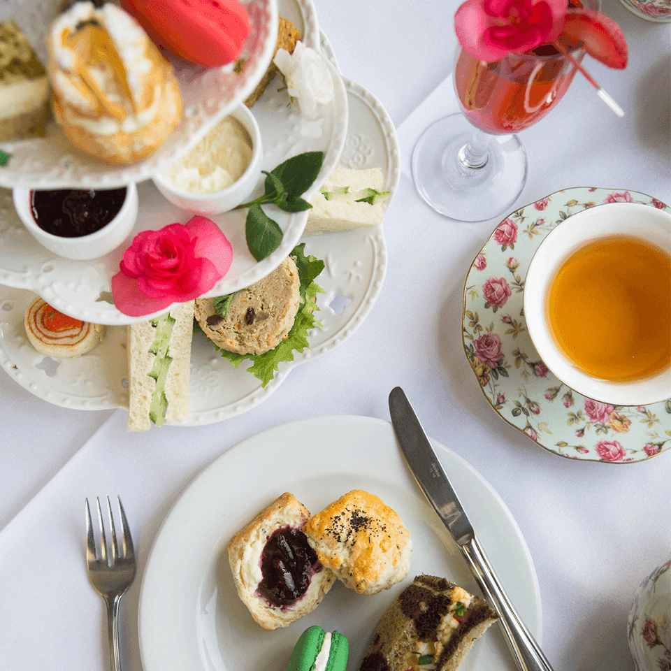 Cup of tea, pastries, & sweets served on a table in Pendray Tea House at Pendray Inn & Tea House