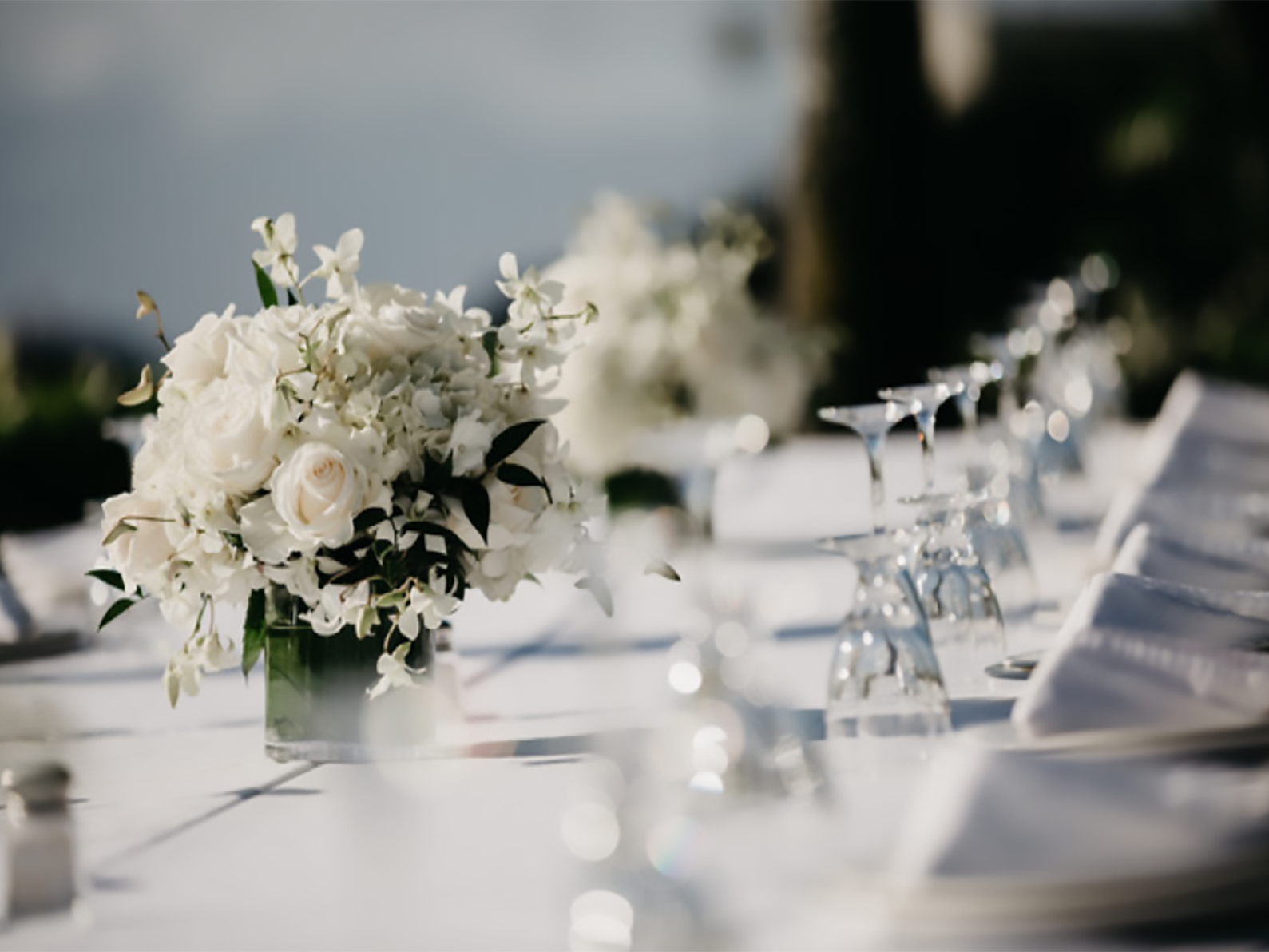 wedding table with glasses and white roses