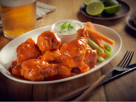 Buffalo wings with hot sauce & a glass of whiskey, One Hotels