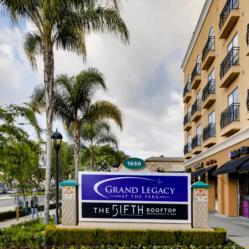 Grand Legacy at the Park building and sign with The Fifth Rooftop Restaurant and Bar.