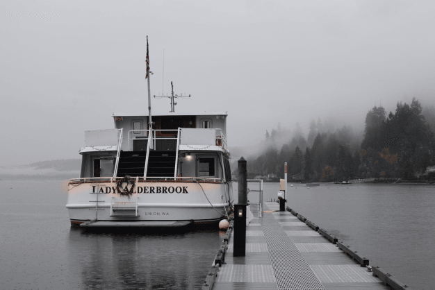 A serene boat floating gently on calm water near Alderbrook Resort & Spa