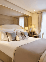 Bed under hanging lamps with a work desk near window in the Superior Single Room at Hotel Westminster Paris