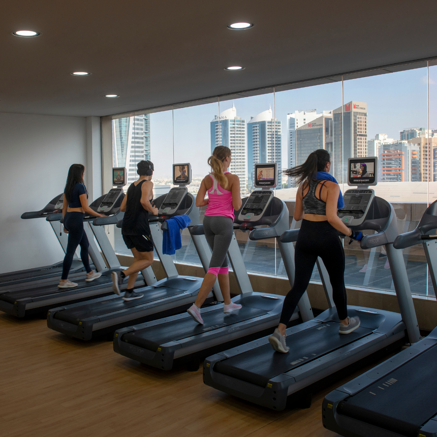 Girls running on treadmills in gym at 2 Seasons Hotel & Apt