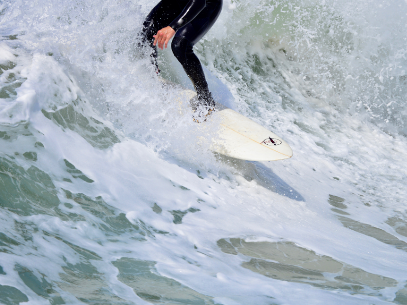 A surfer riding a wave near our Wildwood Crest NJ hotel