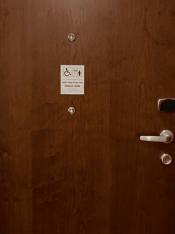 Wooden door with accessibility signage marking the Accessible Room King at Warwick Hotel & Spa - Jeddah