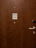 Wooden door with accessibility signage marking the Accessible Room King at Warwick Hotel & Spa - Jeddah