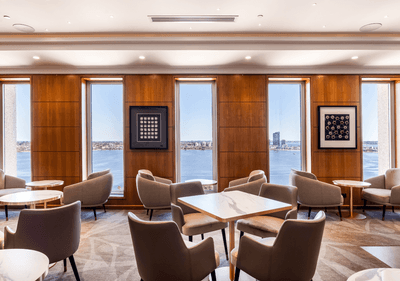 Bright, modern lounge with plush chairs and round tables, in Club Twin at Duxton Hotel Perth