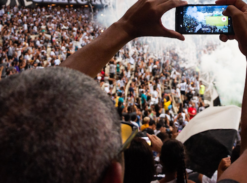 A man recording with his phone at a show near Richmond Hill