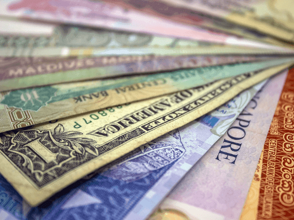 Close-up of currency from countries at Carlton Hotel Singapore