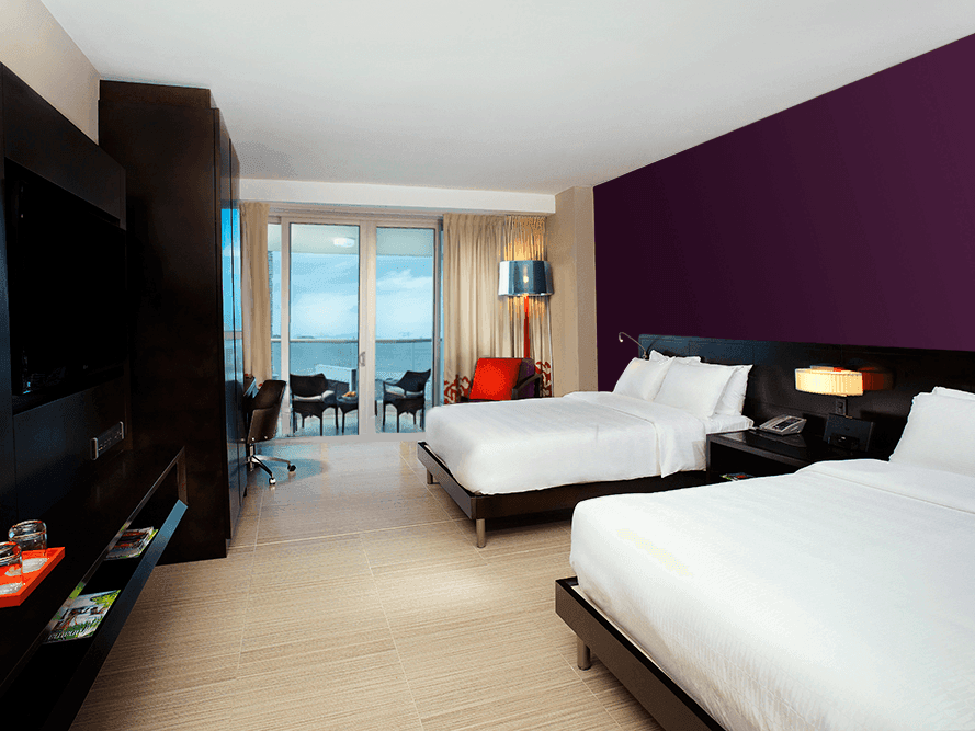 Beds and TV area in Junior Double with Balcony at Megapolis Hotel Panama