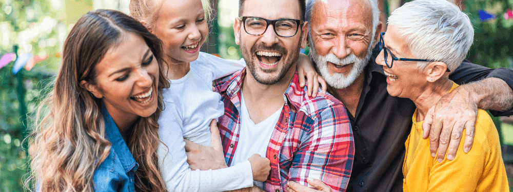 Cheerful multi-gen family sharing laughs and hugs at Novotel Sydney International Airport