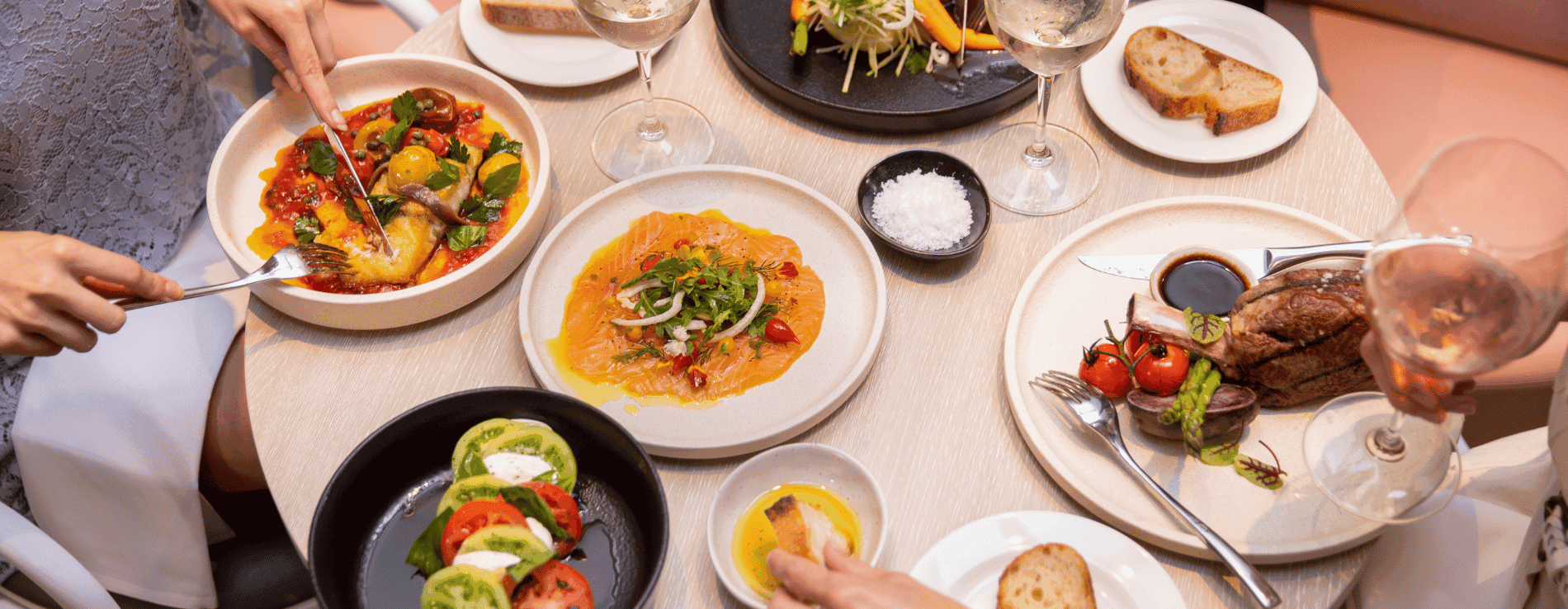 Overhead shot of a table filled with gourmet dishes served at the Novotel Sydney International Airport