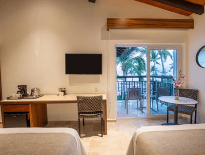 Deluxe Two Double Beds Ocean View with Beds, TV and balcony area at Buenaventura Grand Hotel and Spa