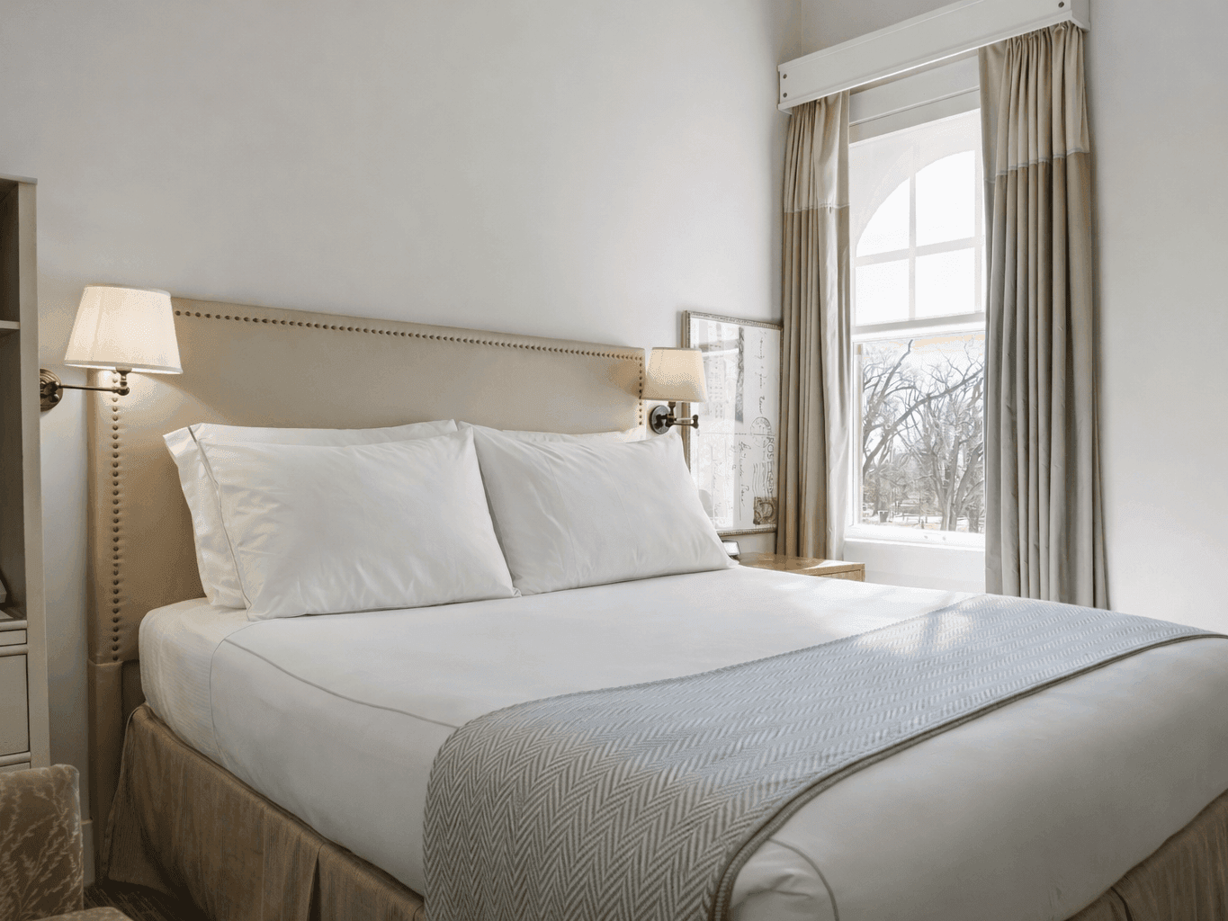 Cozy Traditional King Room with window and lamps at Hotel Parq Central in Albuquerque.