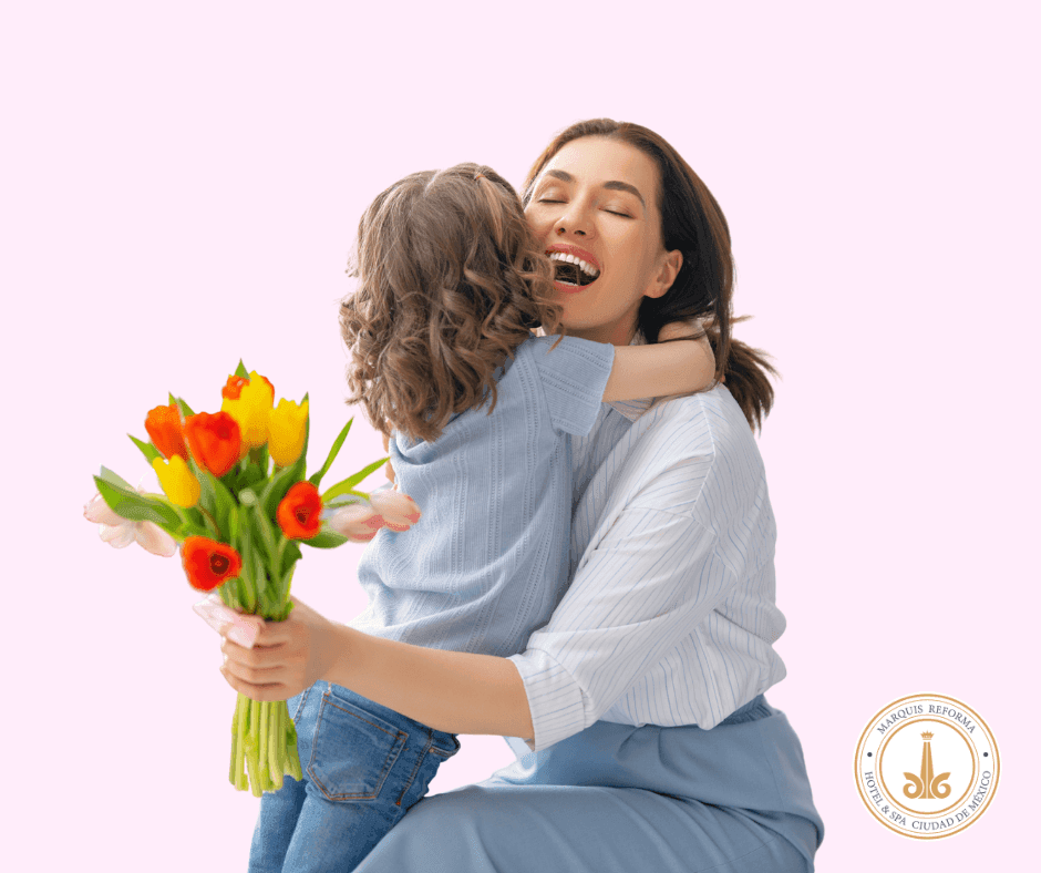 Woman hugging a child while holding a flower bouquet at Marquis Los Cabos