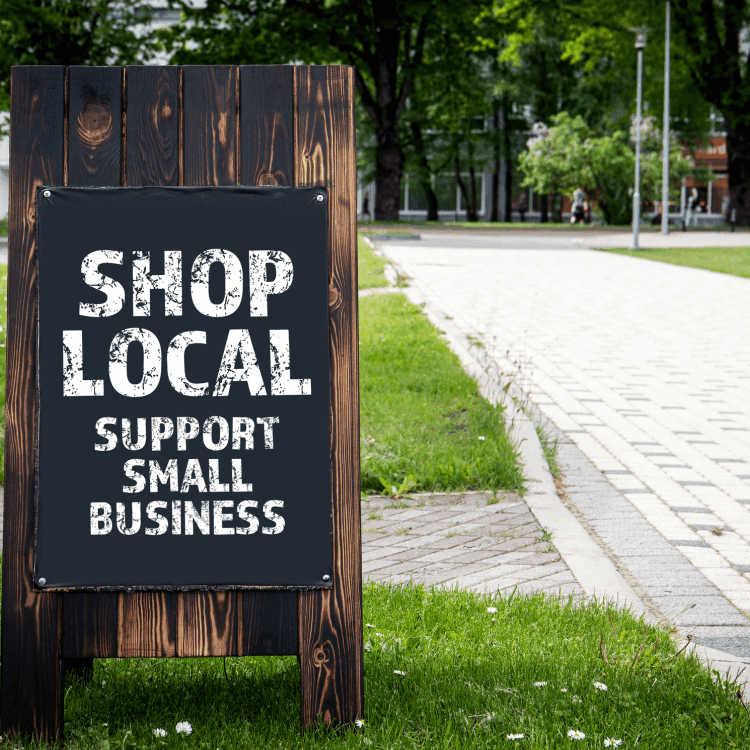 shop local sign on small town road
