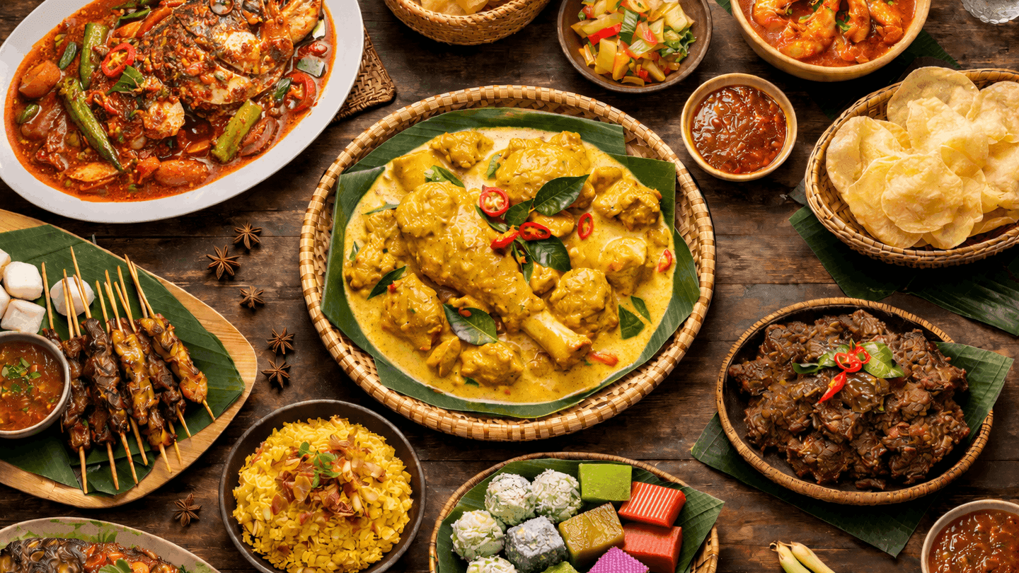 Assorted traditional dishes and desserts on a wooden table showcasing Santapan Istimewa Warisan Turun-Temurun.