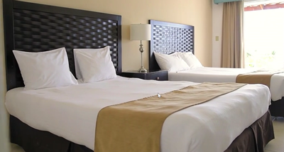 2 double beds in a room at Playa Blanca Beach Resort