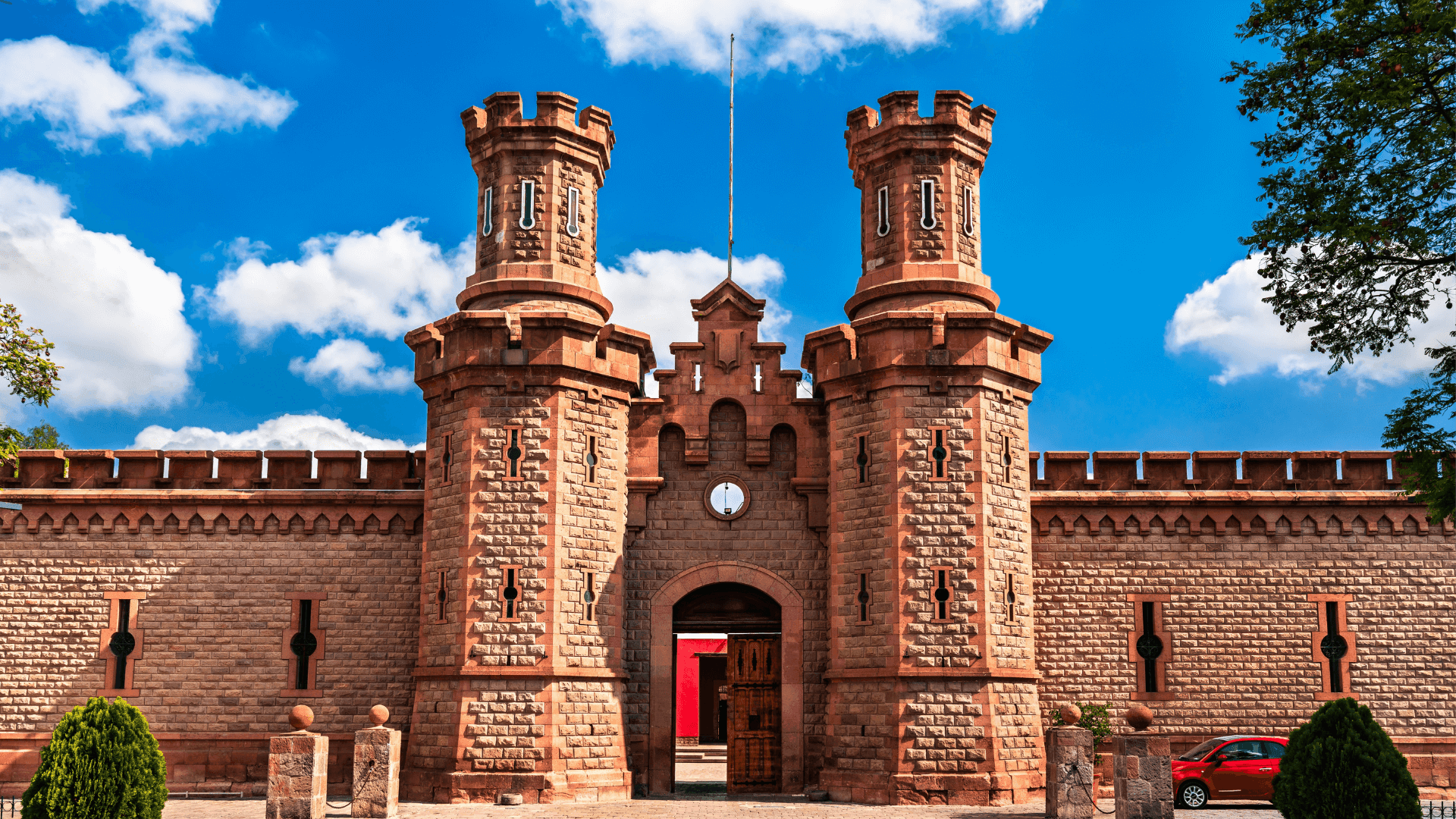 Historic stone entrance of Centro de las Artes de San Luis Potosí under a clear blue sky near Real Inn San Luis Potosi