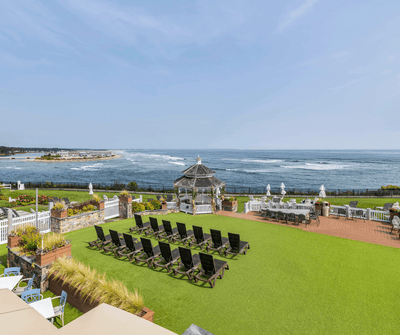 Oceanfront lawn with lounge chairs, gazebo, and coastal views at Anchorage By The Sea