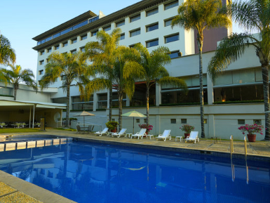 An outdoor swimming pool & sunbeds at Gamma Hotels