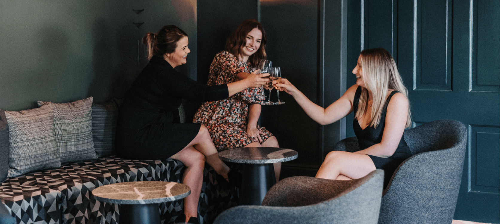 A group of women cheering their glasses in celebration