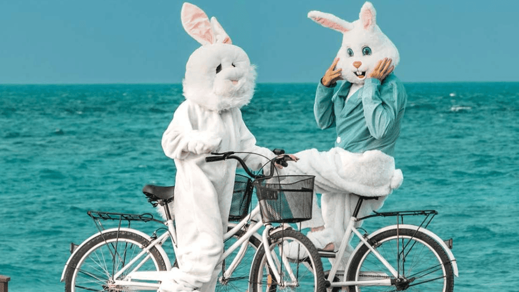 2 bunny mascots on bicycles near The Signature Collection