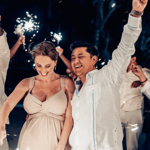 People celebrating with sparklers at night for Your Personalized Weekend Awaits event.