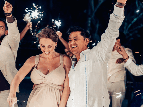 People celebrating with sparklers at night for Your Personalized Weekend Awaits event.