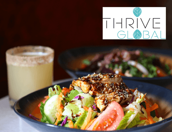 Thrive Global poster with a chicken salad & drink in the background at Hotel Jackson