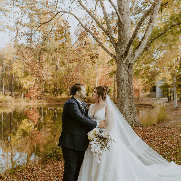 Newly Wed couple embracing in fall setting