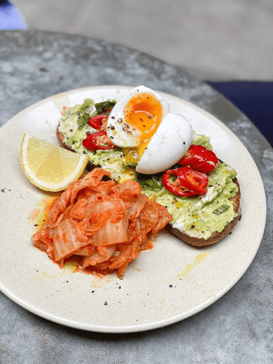 Eggs served with sandwich and kimchi at Nesuto Woolloomooloo Sydney