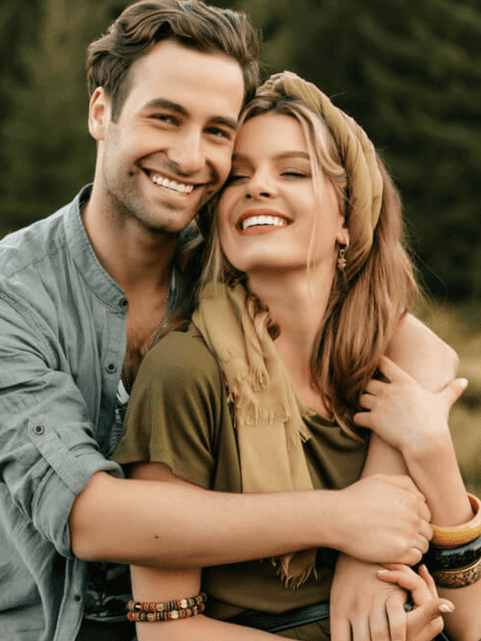 Couple hugging on a field in the evening, featuring capturing love at Cove Pocono Resorts