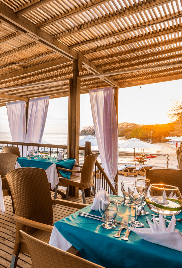Don Juancho with dining tables overlooking the ocean at Hotel Isla Del Encanto