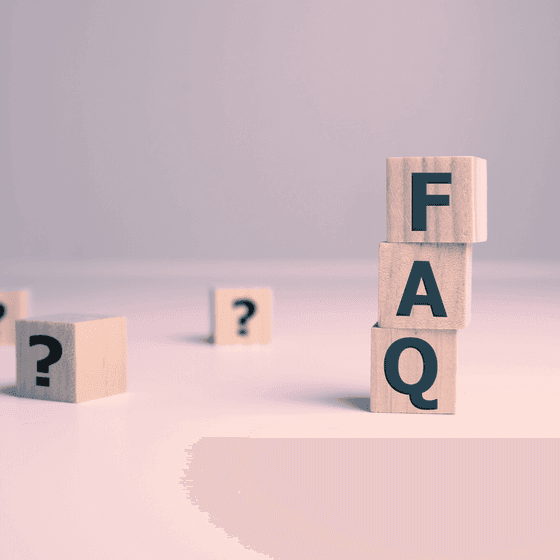 Wooden blocks with 'FAQ' sign on a plain background at La Tourelle Hotel and Spa